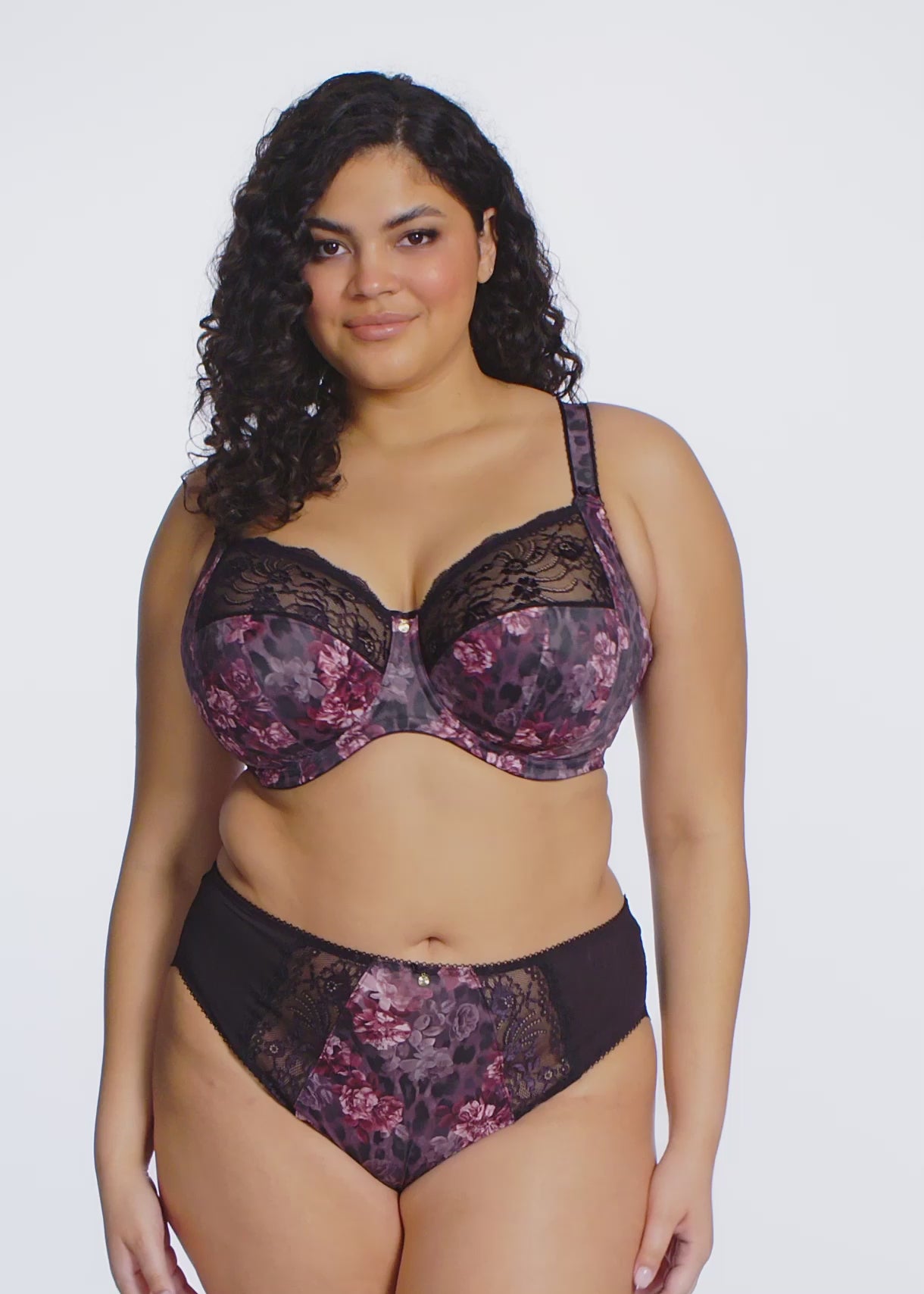 curvy woman wearing a bra and high waist brief with dark floral and lace pattern