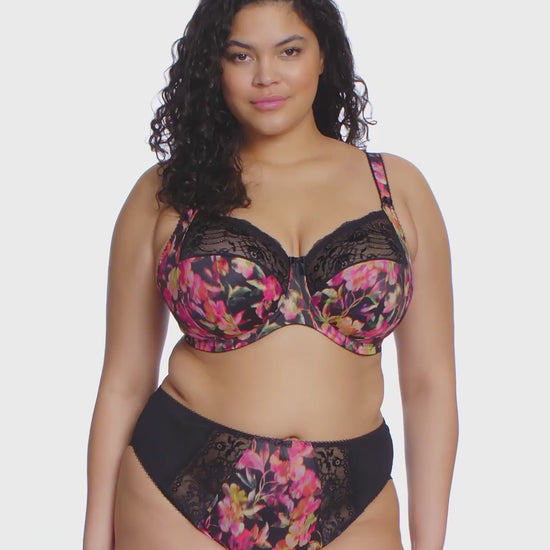 curvy woman wearing a plussize bra in black with colourfull printed flowers and stretch lace  and matching briefs