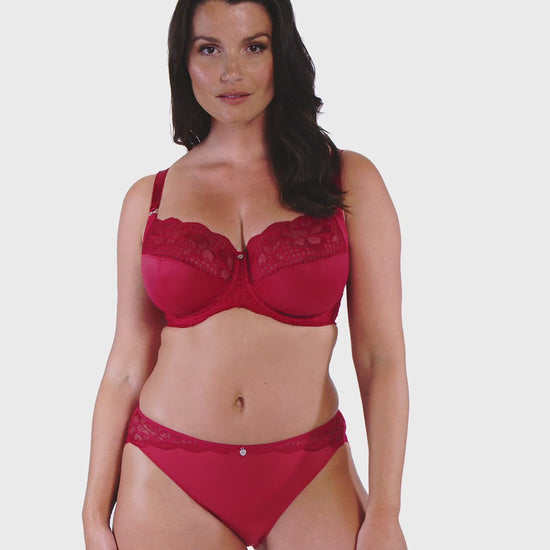 woman wearing a big cup bra with lace details in red and matching brief