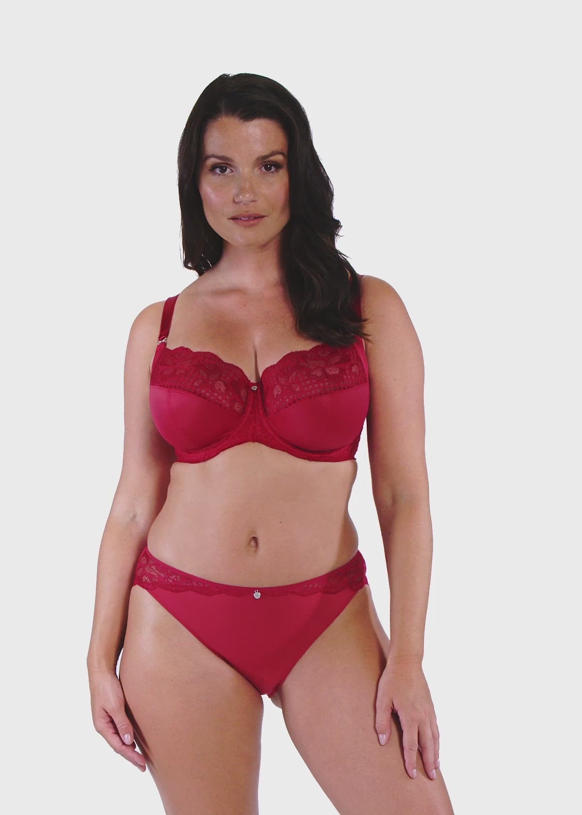 woman wearing a big cup bra with lace details in red and matching brief