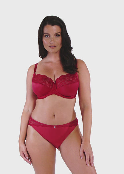 woman wearing a big cup bra with lace details in red and matching brief