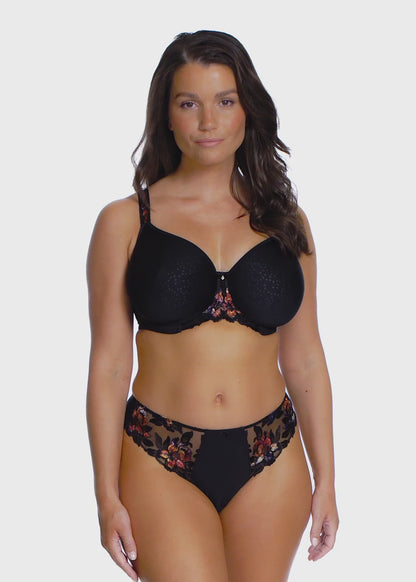 woman wearing a black spacer bra with embroidered floral details in sunset colors