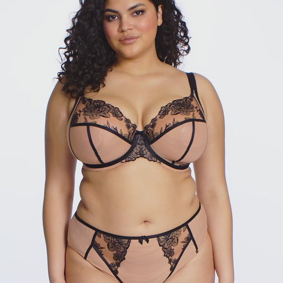 curvy woman wearing Beige underwear with black lace detailing on a white background