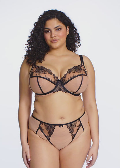 curvy woman wearing Beige underwear with black lace detailing on a white background