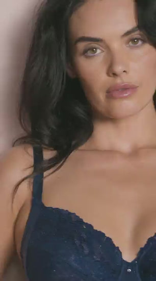woman wearing a dark blue bra with mesh , lace details and strass accents