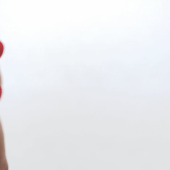 curvy woman wearing a plussize bra with mesh panels in red color against a white background