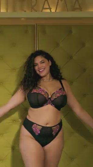 curvy woman wearing a black big cup bra with lace and embroidered flowers in summer colours with matching brief