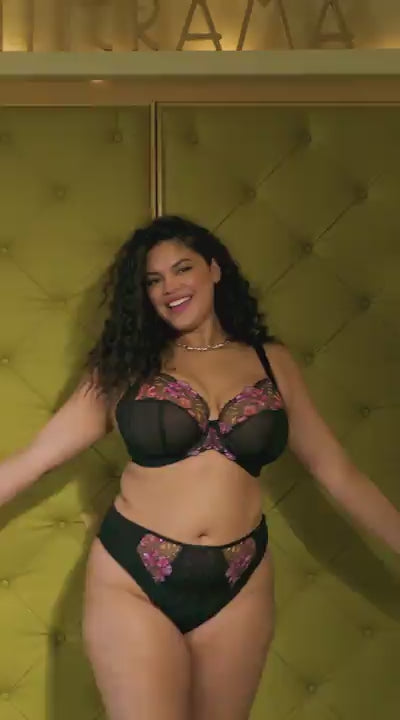 curvy woman wearing a black big cup bra with lace and embroidered flowers in summer colours with matching brief