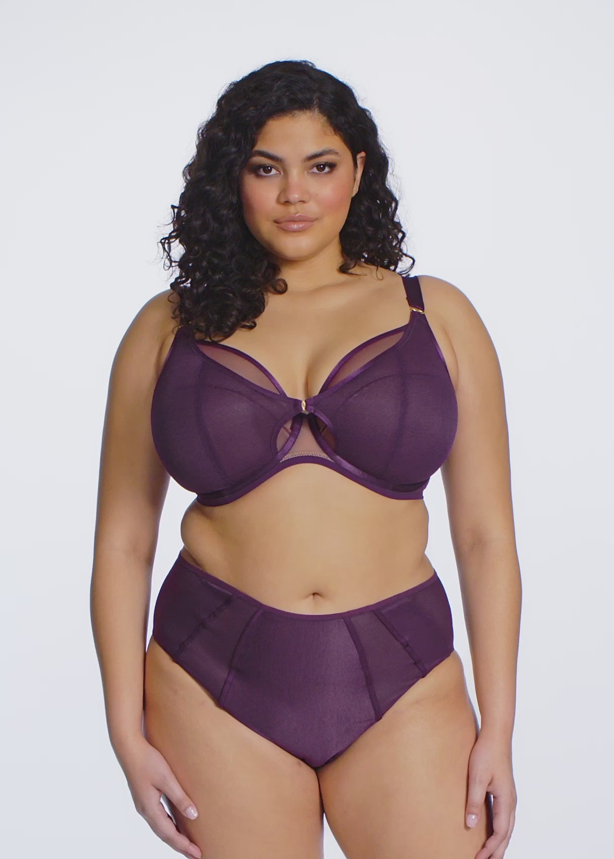 curvy woman wearing a blackberry color big cup bra in mesh with matching brief