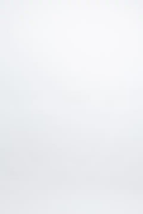 plussize woman wearing a black lingerie set against a white background